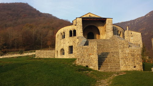 Old building on field against sky