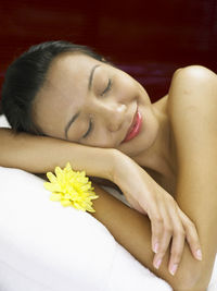 Woman having spa treatment while lying on massage table