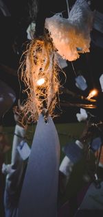 Close-up of woman holding burning candle