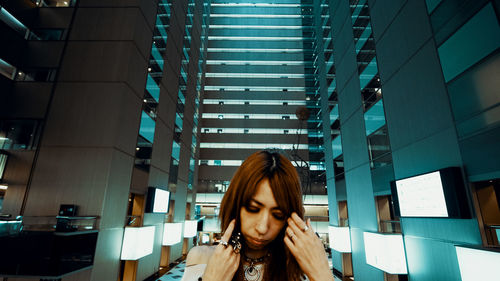 Portrait of woman against building