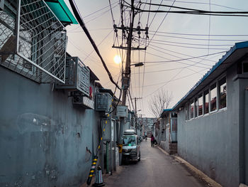 Street amidst buildings against sky in city