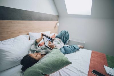 Girl uses her tablet to sketch, finding solace and therapeutic escape through her digital drawings