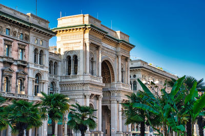 Glden sunshine is reflecting on the triumphal arch entrance of the galleria vittorio emanuele ii