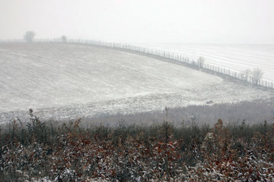 Scenic view of landscape against sky during foggy weather