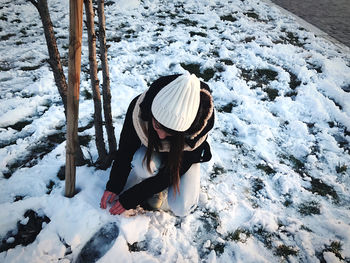 High angle view of woman on snow covered field