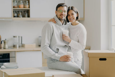 Couple with cardboard boxes at new home