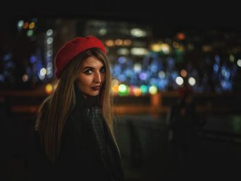 Portrait of young woman at night