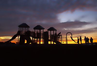 Silhouette of gazebo against cloudy sky during sunset