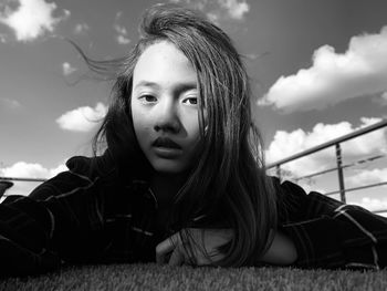 Portrait of girl against sky