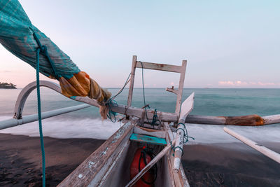 Man fishing in sea against sky