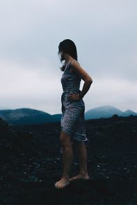 Full length of woman standing on rock
