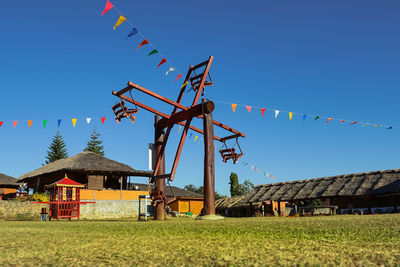 Traditional windmill on field against clear sky