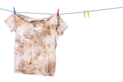 Close-up of clothes drying against white background