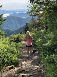 Rear view of woman standing on mountain