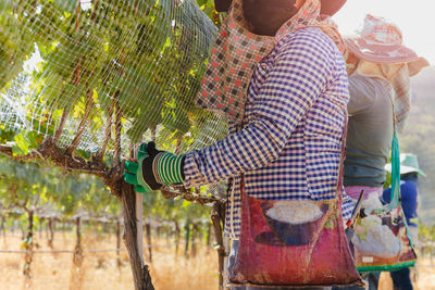 Rear view of woman standing against sky