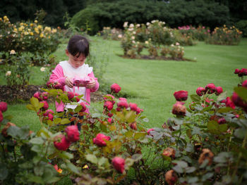 Cute girl holding toy standing at park