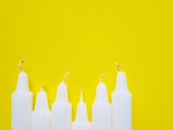 Close-up of yellow paint over white background