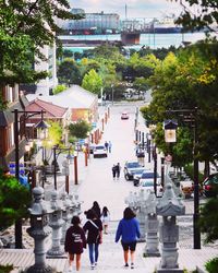 High angle view of people walking on street in city