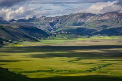 Scenic view of landscape and mountains against sky