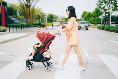 Side view of a woman walking on footpath