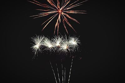 Low angle view of firework display at night