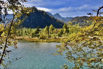 Scenic view of lake and mountains against sky