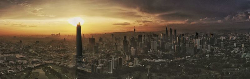 Panoramic view of city against sky during sunset