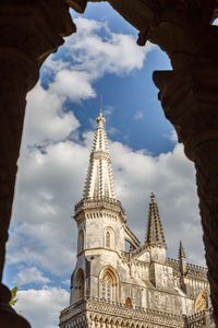 Low angle view of cathedral against cloudy sky