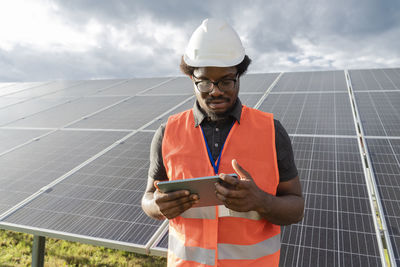 Engineer using tablet pc at solar station