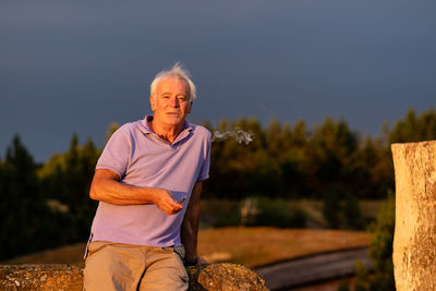 Portrait of man against trees against sky