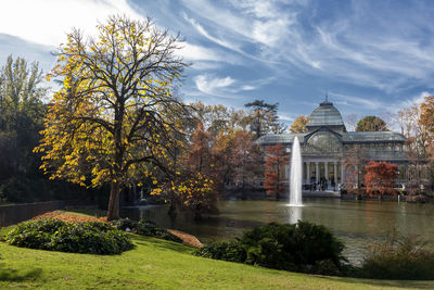 View of trees by lake against cristal palace
