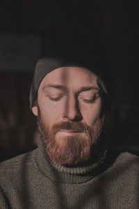 Close-up portrait of young man wearing hat