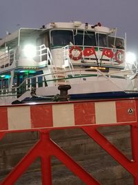 Low angle view of illuminated red ship at night