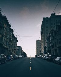 Cars parked on street amidst buildings in city