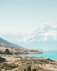 Scenic view of sea and mountains against sky