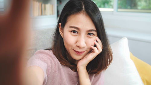 Portrait of smiling woman at home