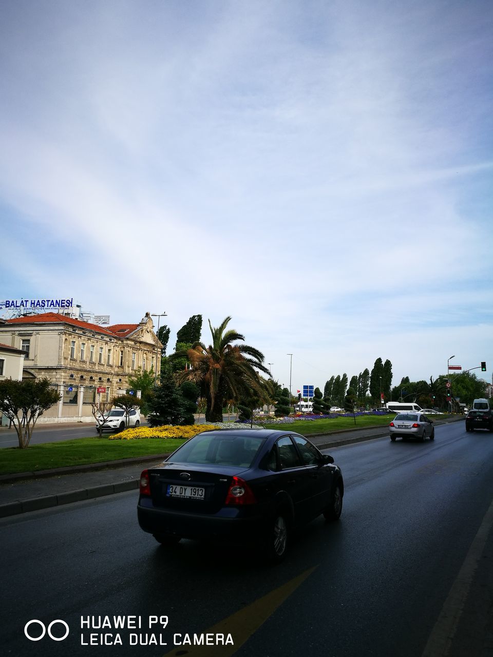 car, architecture, transportation, land vehicle, sky, road, built structure, mode of transport, building exterior, day, outdoors, city, no people, tree