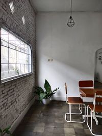 Empty chairs and table against wall at home