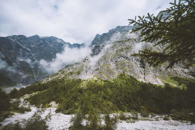 Scenic view of waterfall in forest against sky