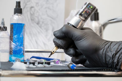 Cropped hand of woman drinking glass