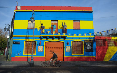 Bicycles on road against blue sky