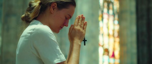 Side view of young woman using mobile phone