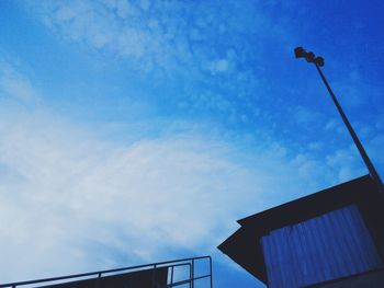 Low angle view of street light against blue sky