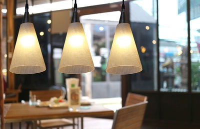 Close-up of illuminated lamp on table at home