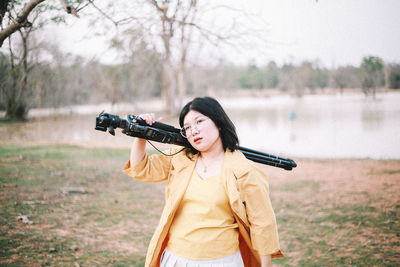 Rear view of man photographing while standing against trees