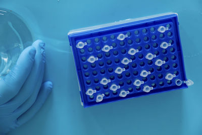 High angle view of cropped hands on table