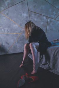 High angle view of woman sitting on tiled floor
