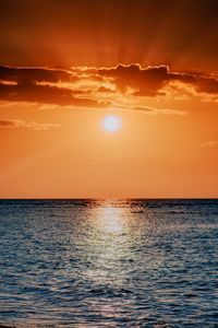 Scenic view of sea against orange sky