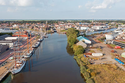 High angle view of townscape by sea against sky