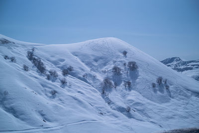 Scenic view of snow covered mountain against sky